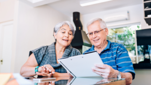 Older couple reviewing tax optimization documents from a financial planning firm in Greenville, SC