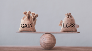 gain' and the other 'loss,' being weighed to represent the balance of gains and losses in tax loss harvesting, as part of a financial plan with Ballentine Capital Advisors, a financial planner in Greenville, SC