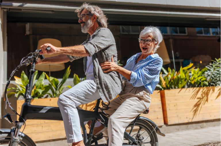 A couple enjoying a bike ride, symbolizing financial freedom and a well-planned retirement with Ballentine Capital Advisors.