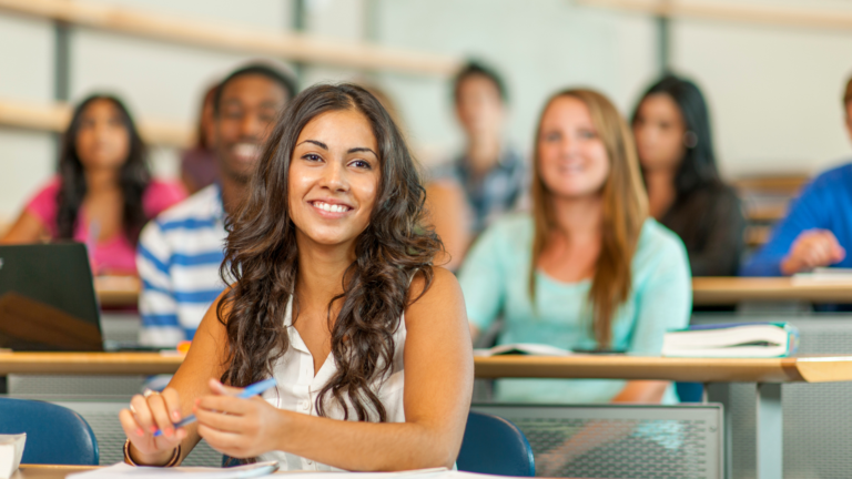 A college student attentively taking notes in class, preparing for her future education and financial goals.