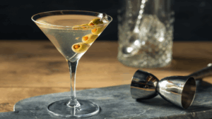 A chilled classic martini garnished with olives on a sleek bar counter, featured in BCA Private Wealth’s Recipe of the Week to celebrate National Martini Day with style and flavor.