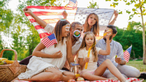Family celebrating Fourth of July with American flags, symbolizing freedom and patriotic spirit